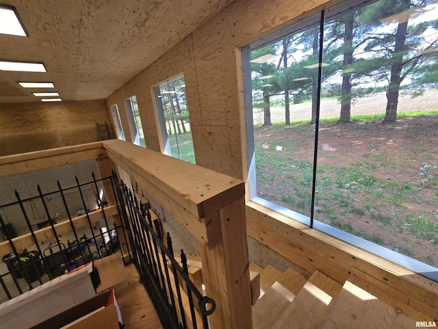 stairs featuring wood walls