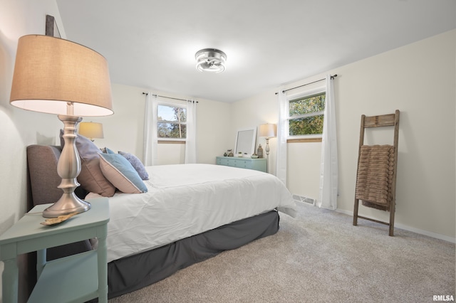 bedroom featuring carpet floors, baseboards, and visible vents
