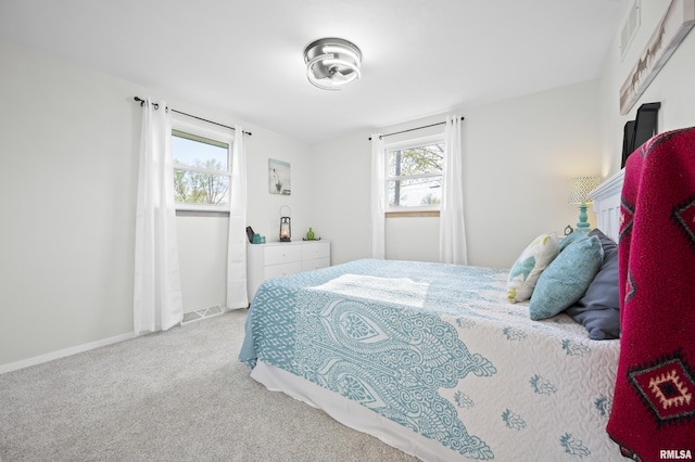 carpeted bedroom with baseboards and visible vents