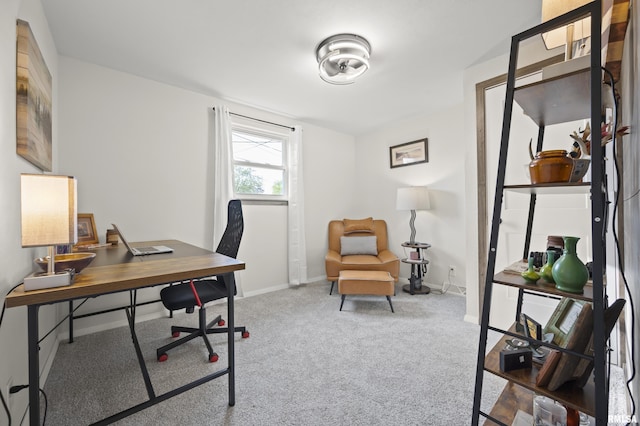 carpeted home office featuring baseboards