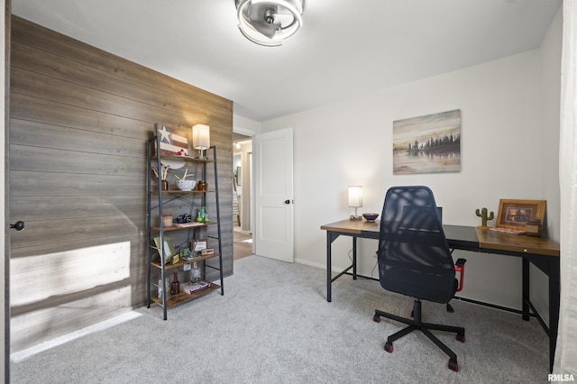 office area featuring carpet floors and wood walls
