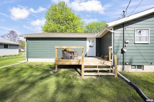 back of house featuring a yard and a deck