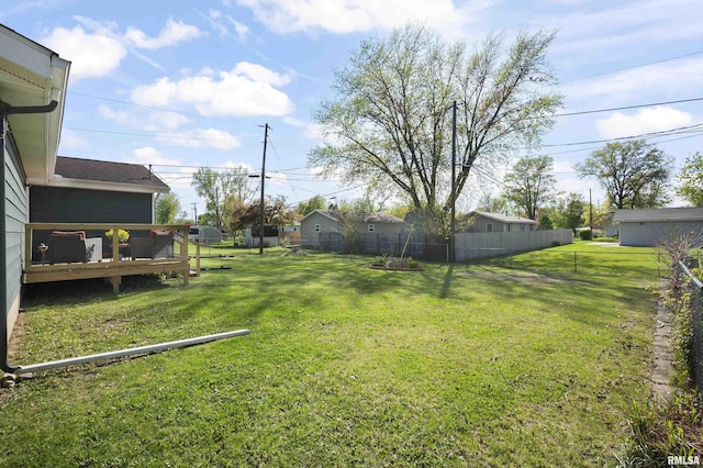 view of yard featuring fence and a deck