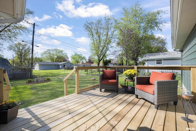 wooden terrace featuring a lawn and a fenced backyard