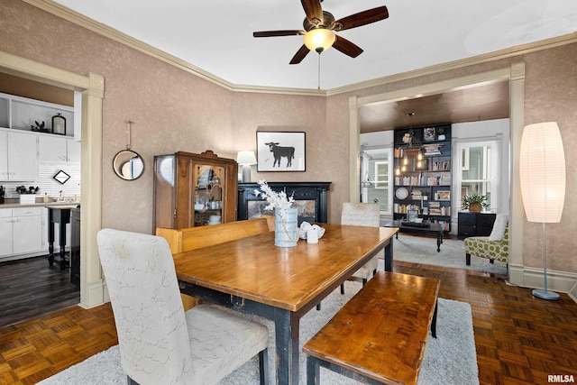 1122 N Broad St, Galesburg, IL 61401 - dining area with a textured wall, ceiling fan, a multi sided fireplace, baseboards, and ornamental molding
