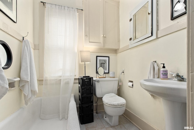 1122 N Broad St, Galesburg, IL 61401 - bathroom with toilet, baseboards, a sink, and tile patterned flooring