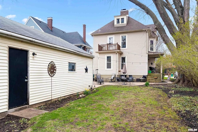 1122 N Broad St, Galesburg, IL 61401 - back of house with a lawn, a patio area, a balcony, and entry steps