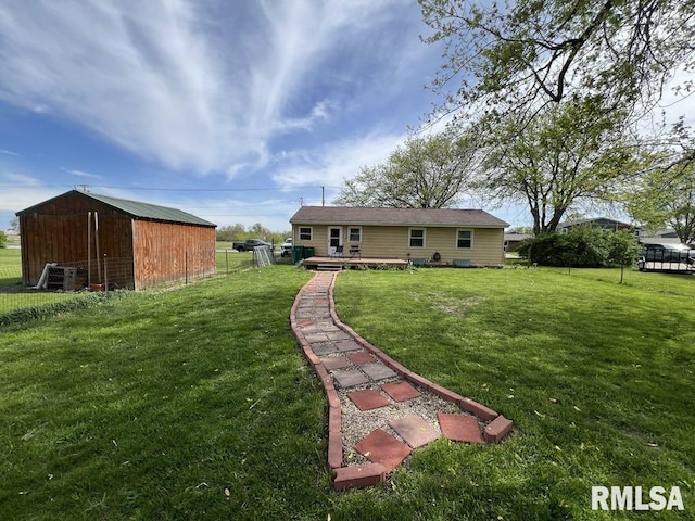 1520 E Wheeler St, Macomb, IL 61455 - back of property featuring a lawn, a wooden deck, and an outdoor structure