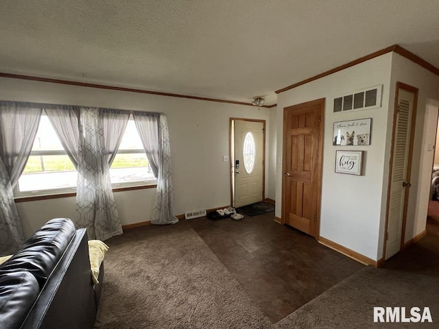 1520 E Wheeler St, Macomb, IL 61455 - entryway with crown molding, a healthy amount of sunlight, dark colored carpet, and visible vents