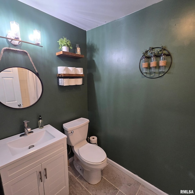 bathroom with vanity, tile patterned floors, and toilet
