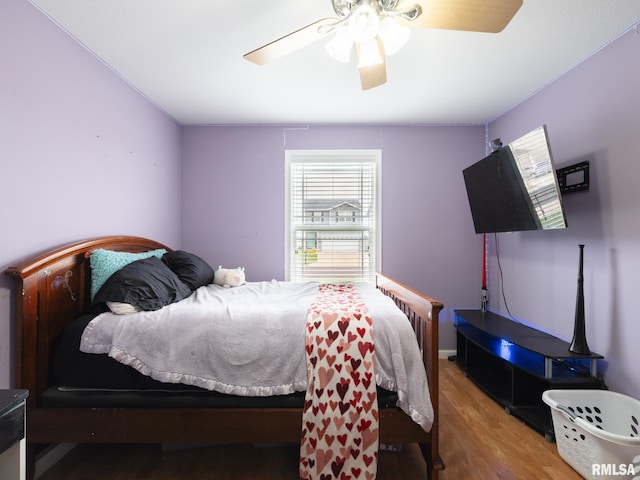 bedroom featuring a ceiling fan and wood finished floors