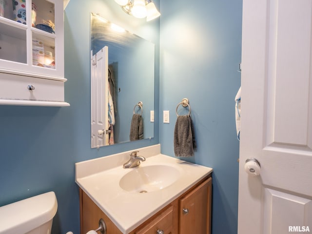half bath with vanity and toilet