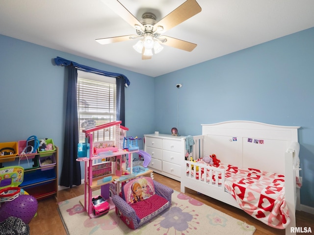 bedroom with ceiling fan and wood finished floors