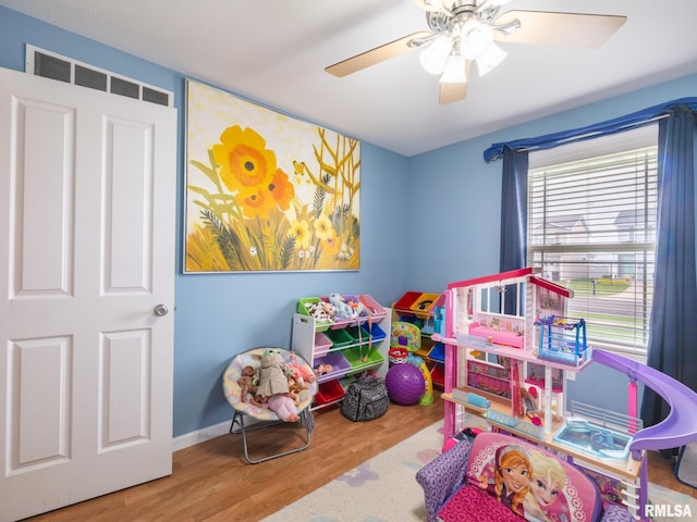 rec room with baseboards, visible vents, wood finished floors, and a ceiling fan