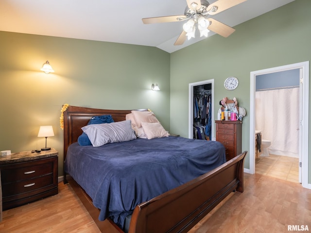 bedroom featuring a closet, light wood-style flooring, high vaulted ceiling, and a walk in closet