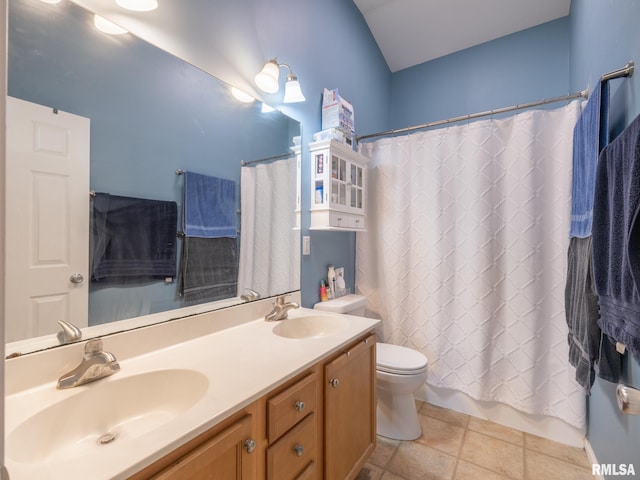 full bath featuring tile patterned floors, double vanity, toilet, and a sink