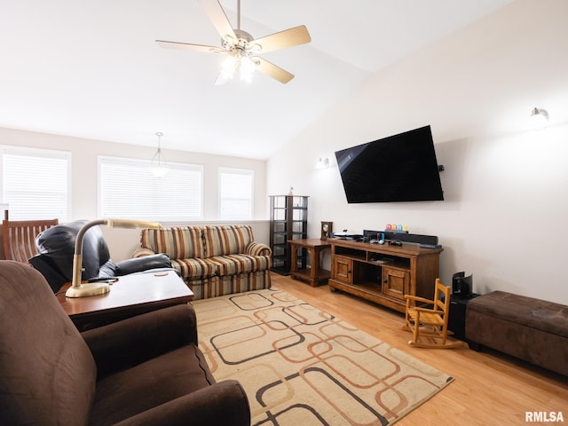 living area featuring light wood-style flooring, lofted ceiling, and ceiling fan