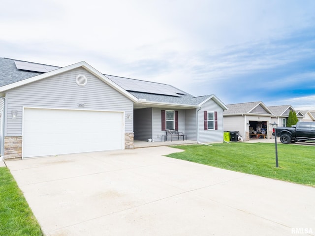 ranch-style home featuring concrete driveway, stone siding, solar panels, and a garage