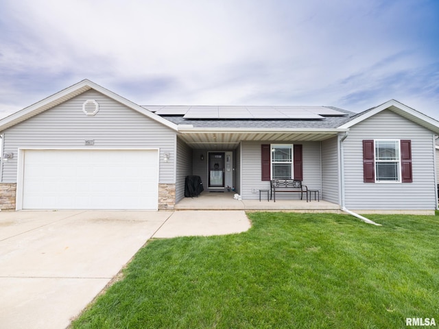 single story home featuring driveway, covered porch, an attached garage, and roof mounted solar panels