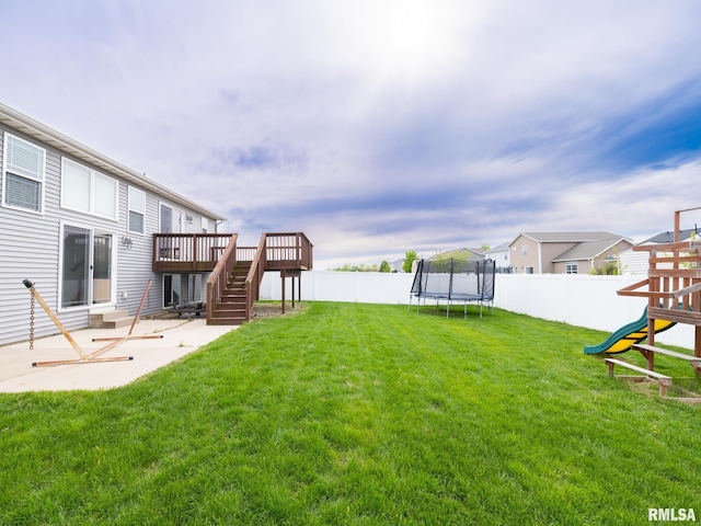 view of yard featuring a fenced backyard, a patio area, a trampoline, and stairs