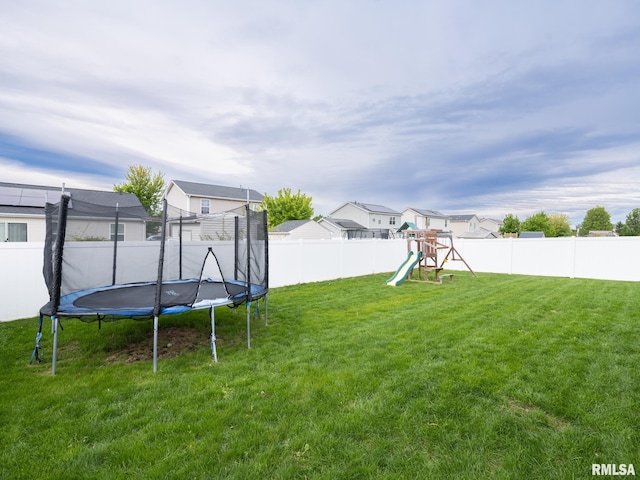 view of yard with a playground, a trampoline, a residential view, and a fenced backyard
