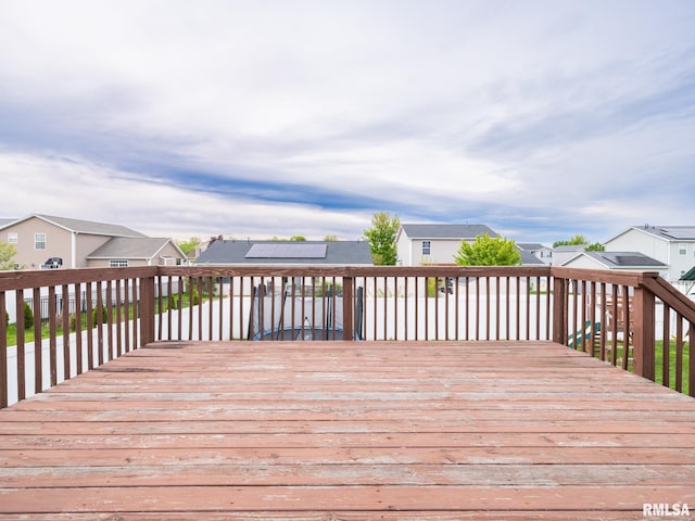 wooden terrace featuring a residential view