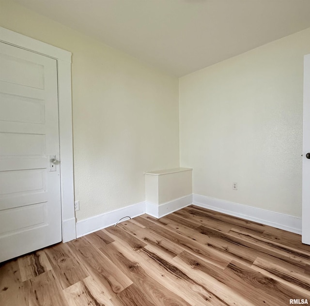 empty room featuring baseboards and wood finished floors