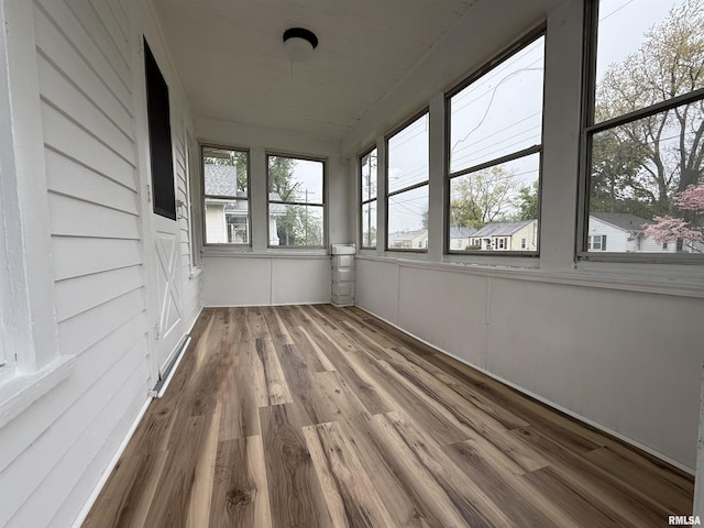 unfurnished sunroom with wood finished floors