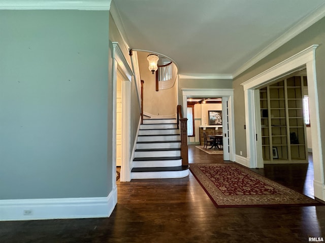 staircase featuring crown molding, baseboards, and wood finished floors