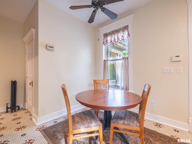 dining room with a ceiling fan and baseboards