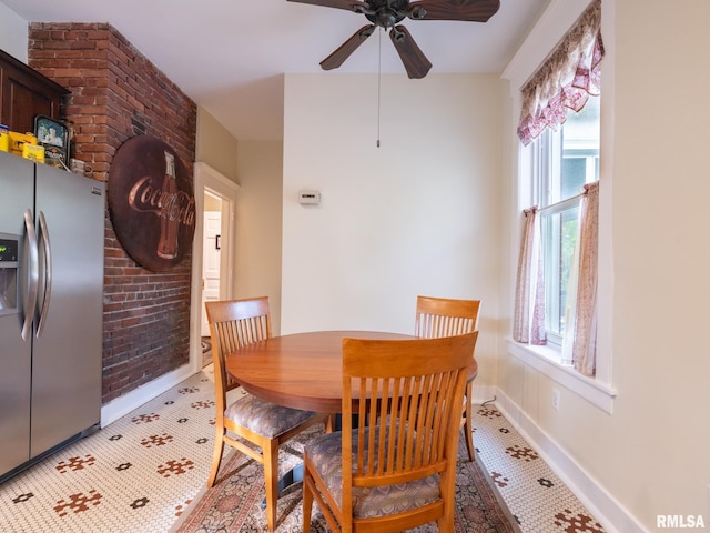 dining room with baseboards, ceiling fan, and tile patterned floors