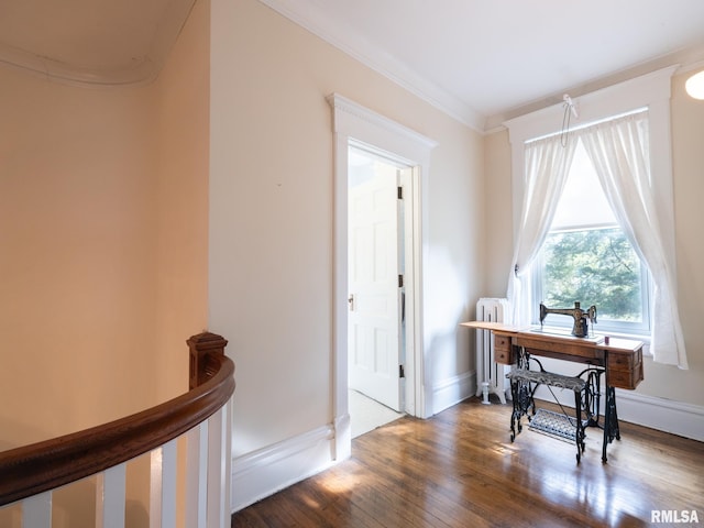office space featuring radiator, ornamental molding, baseboards, and wood finished floors
