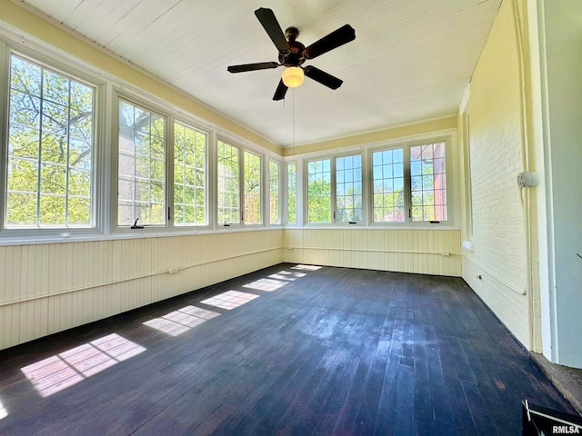 unfurnished sunroom with a ceiling fan and hardwood / wood-style flooring