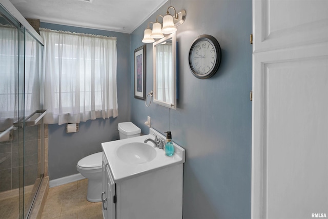 bathroom with vanity, baseboards, a stall shower, and toilet