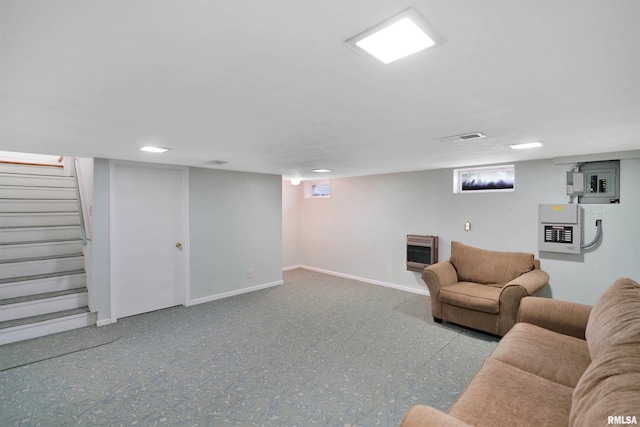 living room with visible vents, heating unit, stairs, and baseboards