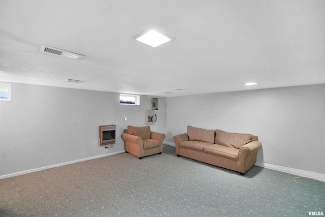 living area featuring baseboards, heating unit, and visible vents