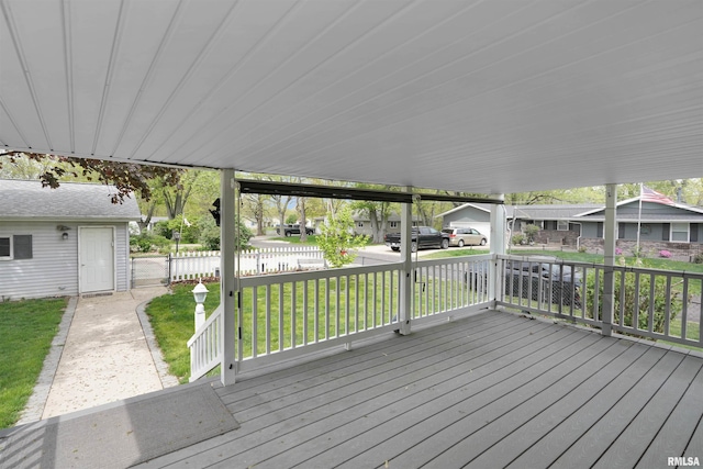 deck with a lawn, fence, and a residential view