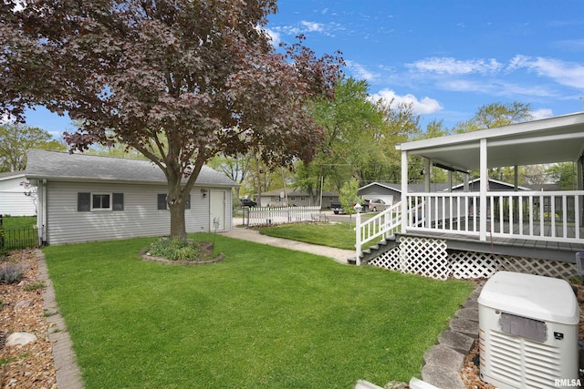 view of yard featuring fence and a deck
