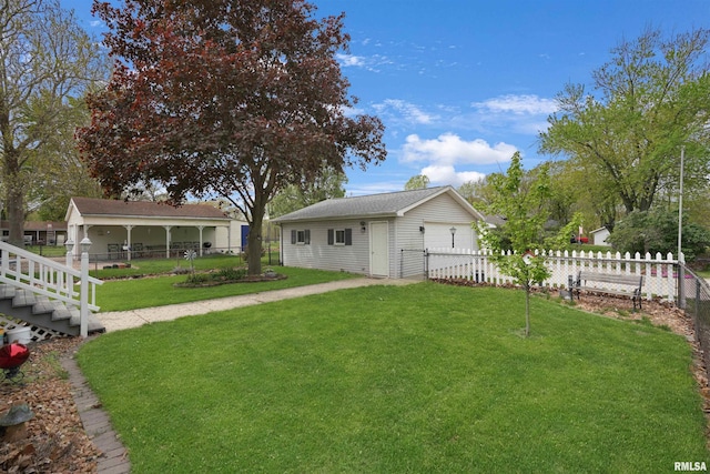 view of front of property with covered porch, fence, an outbuilding, and a front yard