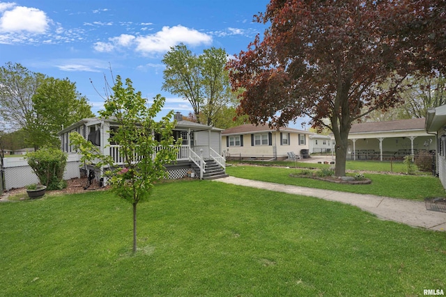 view of front of property featuring a front lawn and fence