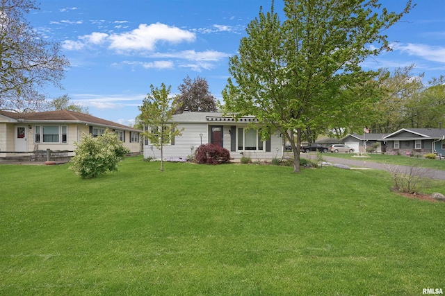 ranch-style home with a front lawn