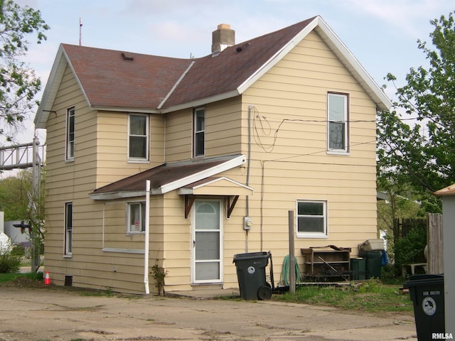 605 S 2nd St, Pekin, IL 61554 - rear view of house with a chimney and a shingled roof