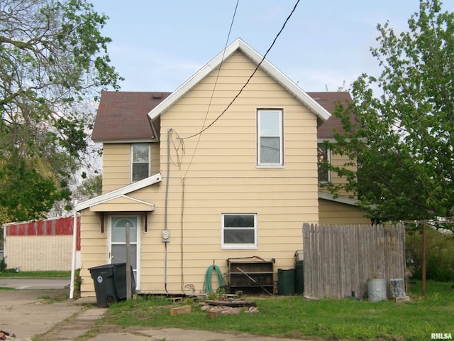 605 S 2nd St, Pekin, IL 61554 - back of property featuring roof with shingles and fence