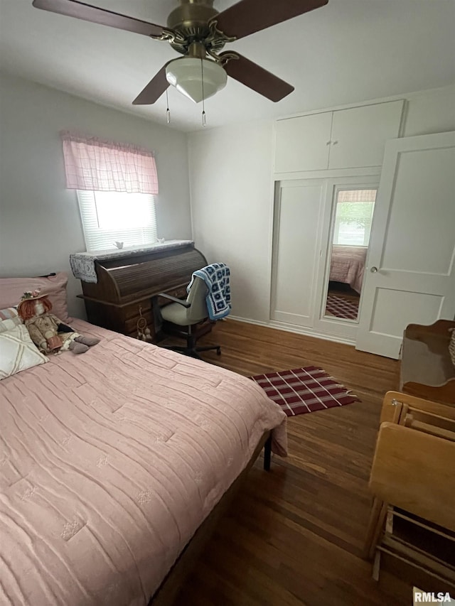 bedroom with a ceiling fan and wood finished floors