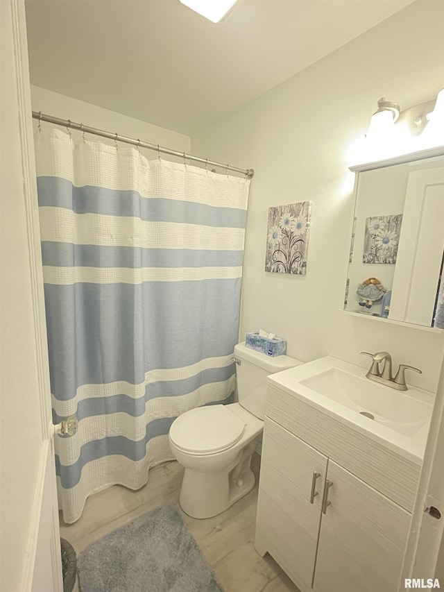 bathroom featuring wood finished floors, toilet, curtained shower, and vanity