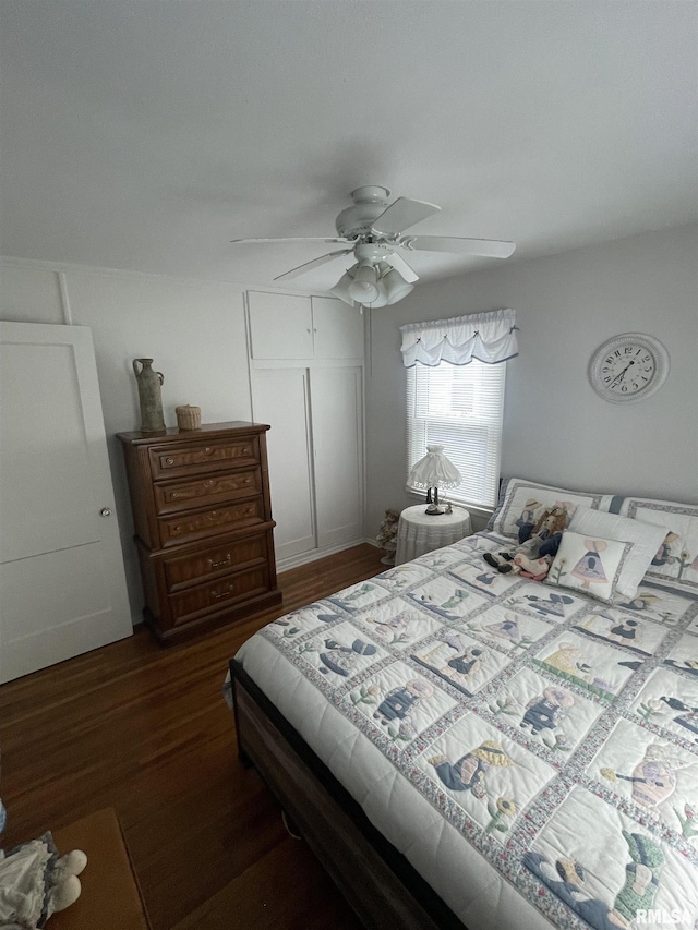 bedroom with a closet, a ceiling fan, and dark wood finished floors