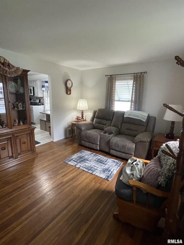 living room with washer / dryer and wood finished floors