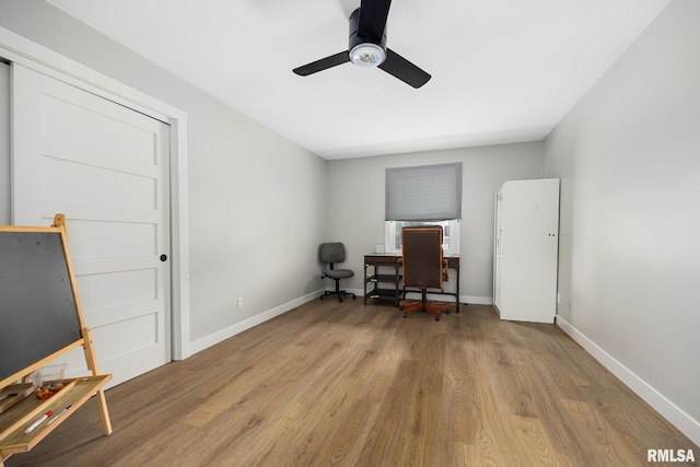 home office with baseboards, ceiling fan, and wood finished floors