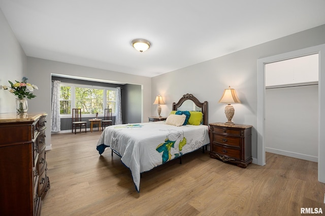 bedroom featuring baseboards and light wood-style flooring