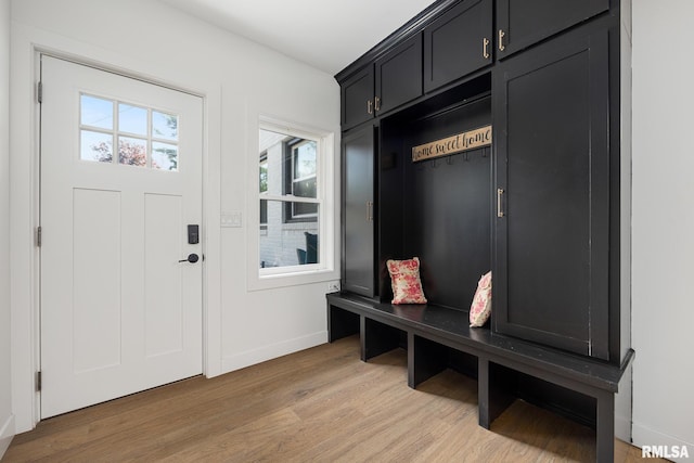 mudroom featuring light wood-type flooring and baseboards